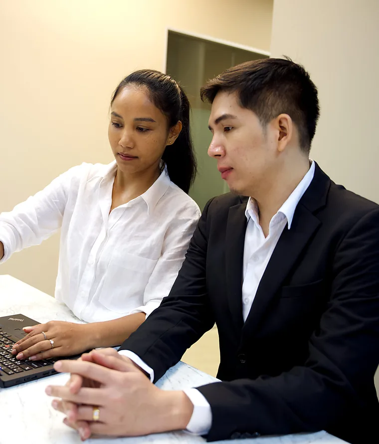 Two YPN Accounting team members working through a client's needs at a laptop