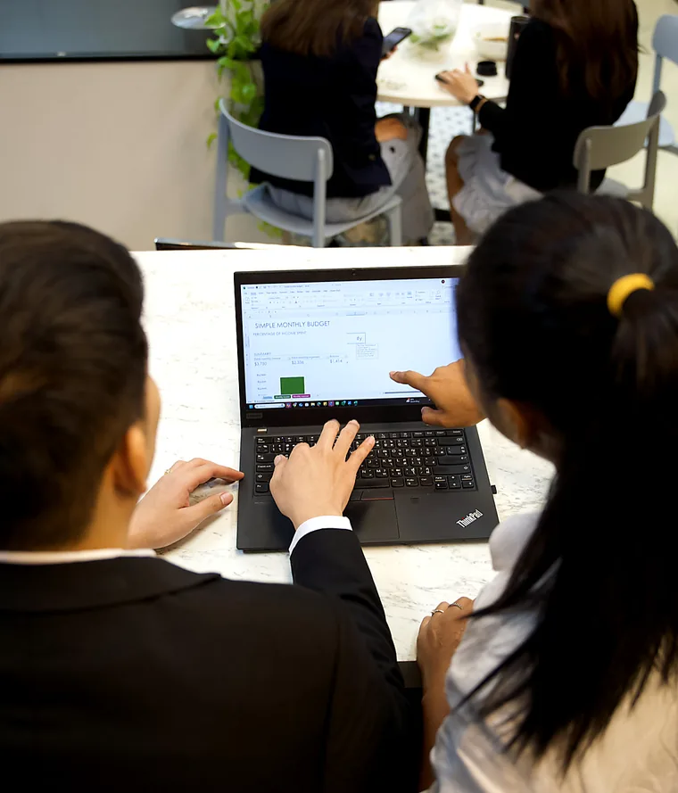 YPN Accounting team members going through a client's monthly figures at a laptop